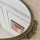 Oval mirror in gilded brass