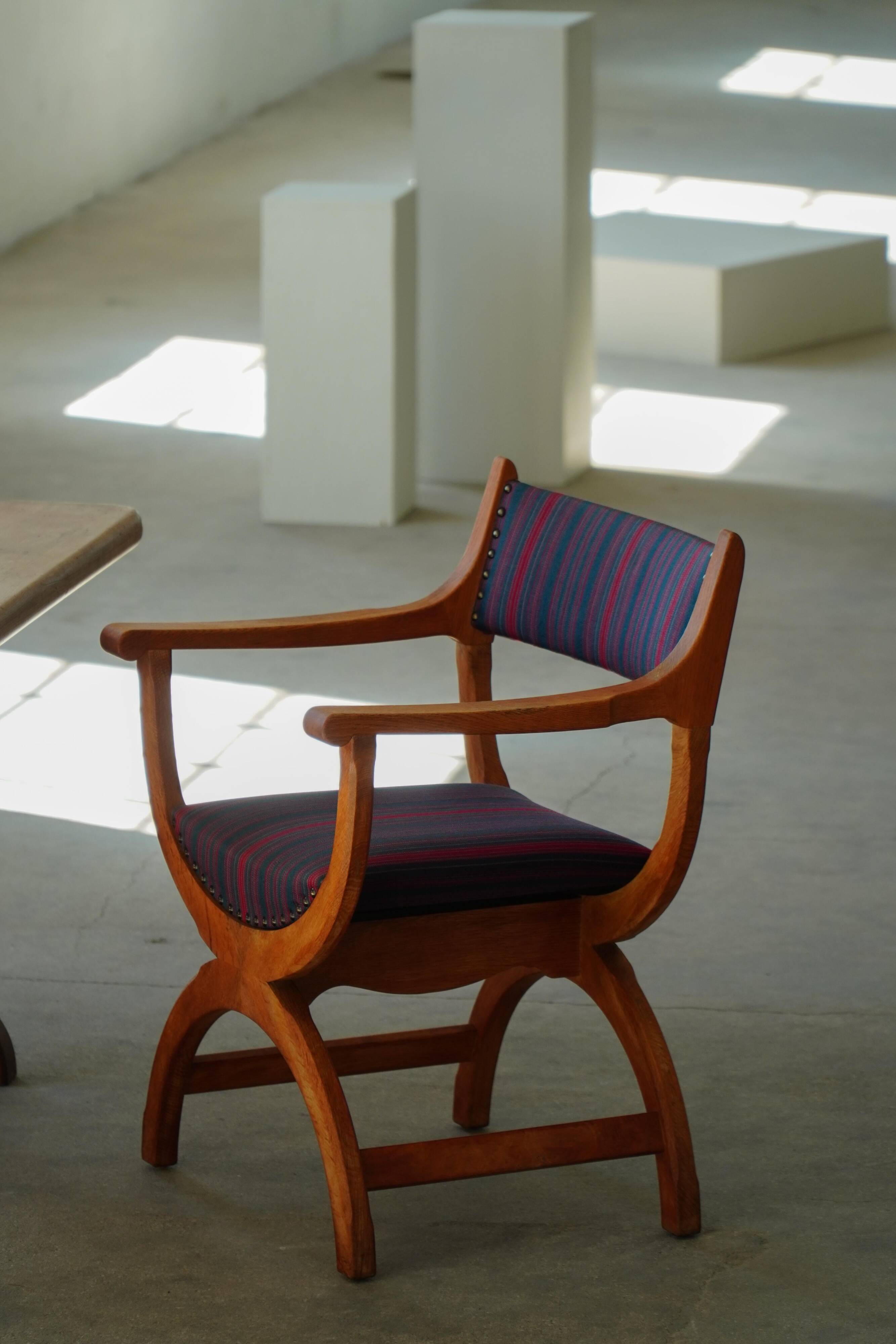 Henning Kjærnulf, pair of oak armchairs, model "Kurul", Danish modern style, 1960s.