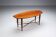 Assymetrical coffeetable with glass storage and cross leg details