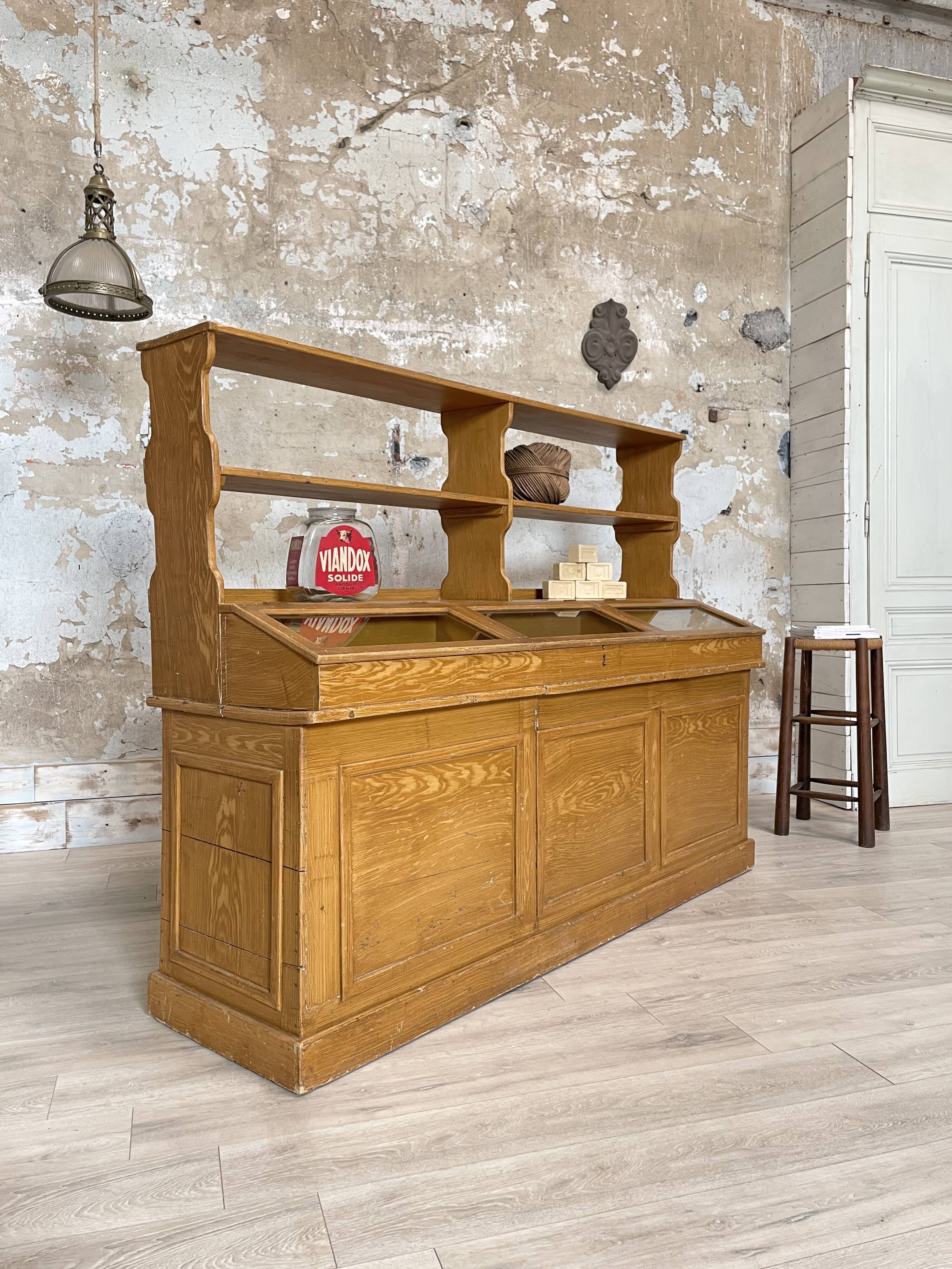 Wooden hardware cabinet painted with wood effect, circa 1940.