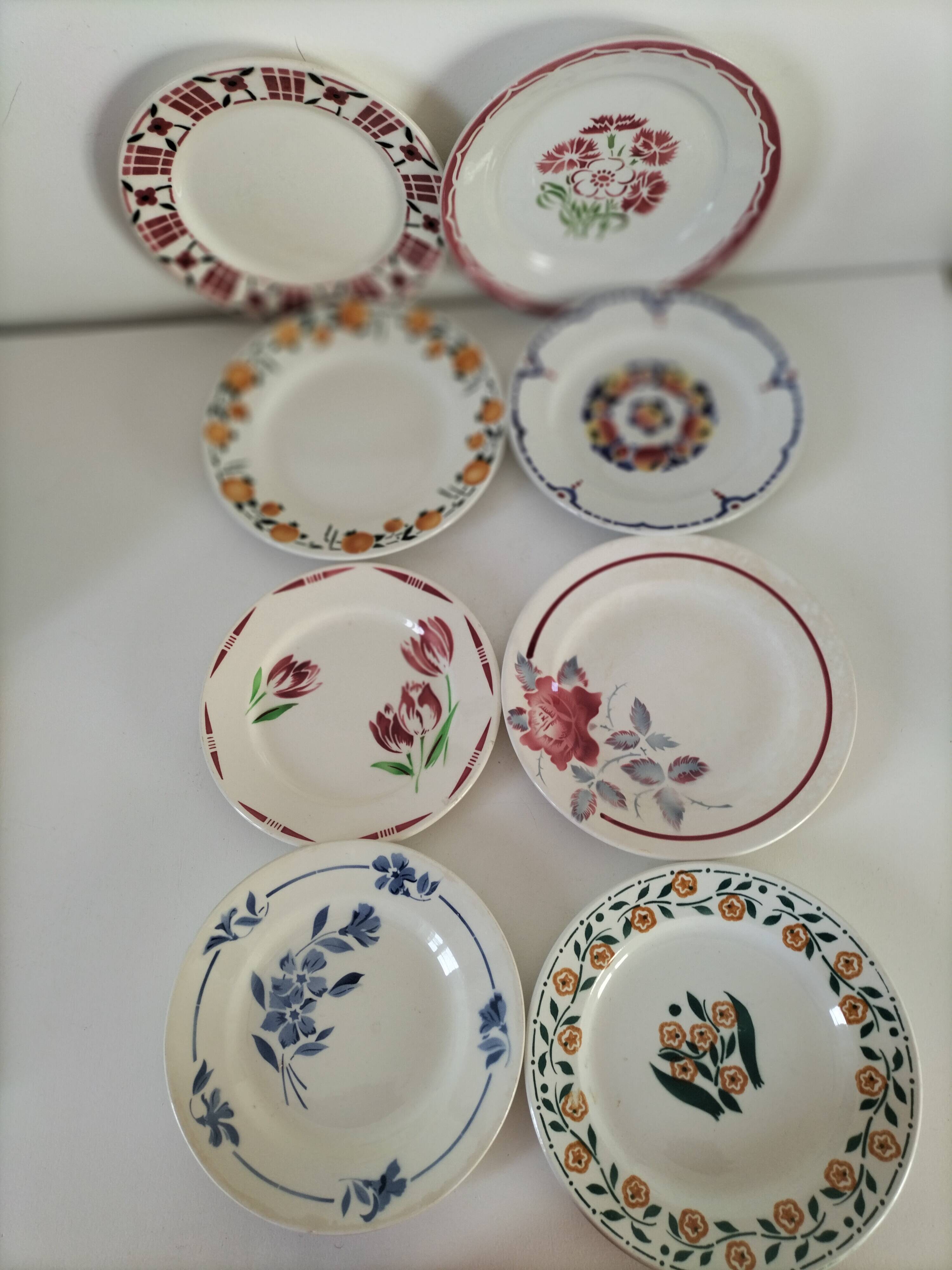 Set of 8 ironstone plates with coordinated designs.