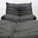 Togo armchair and footrest in black leather by Ligne Roset, designed by Michel Ducaroy.