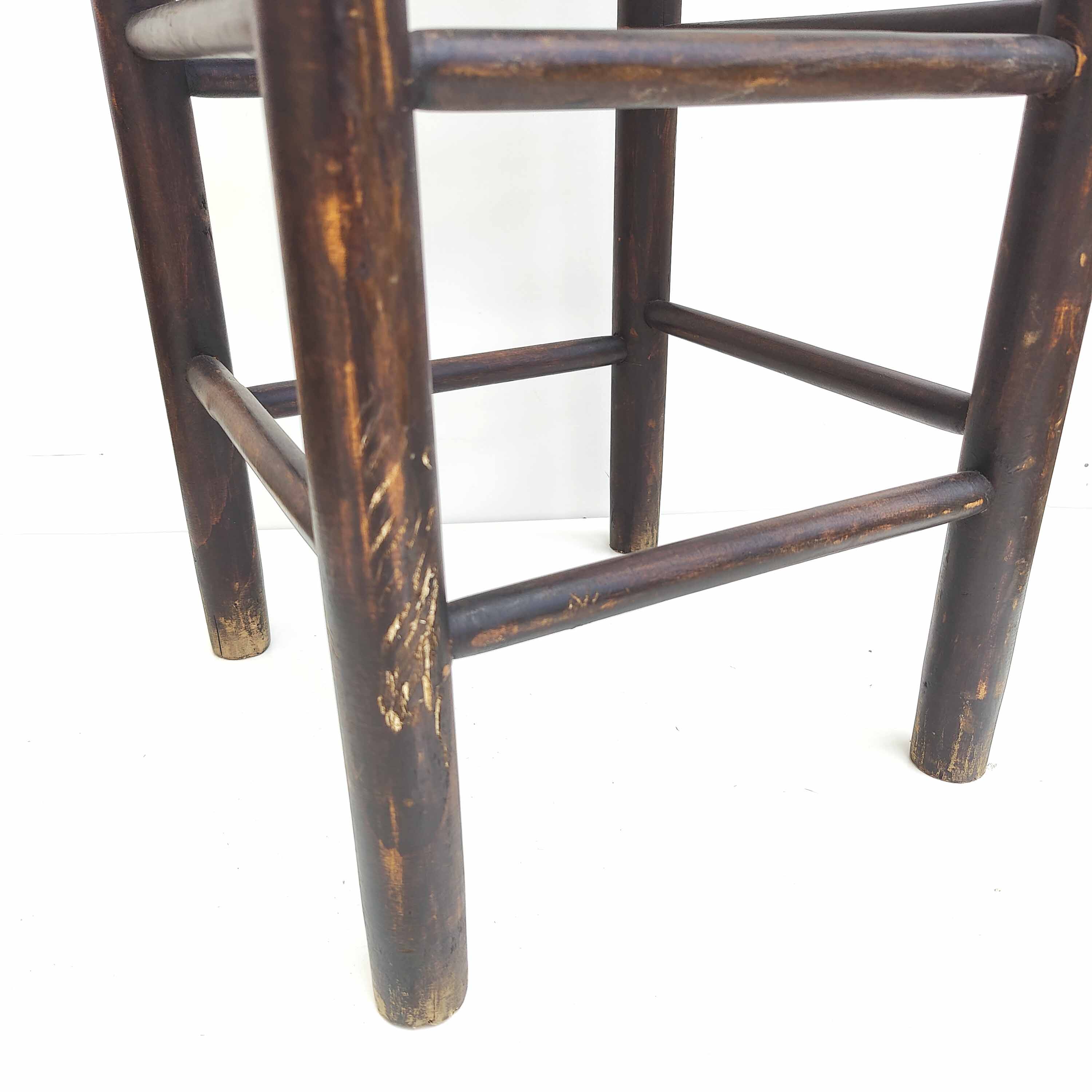 Blackened wooden bar top stool with mulched seat