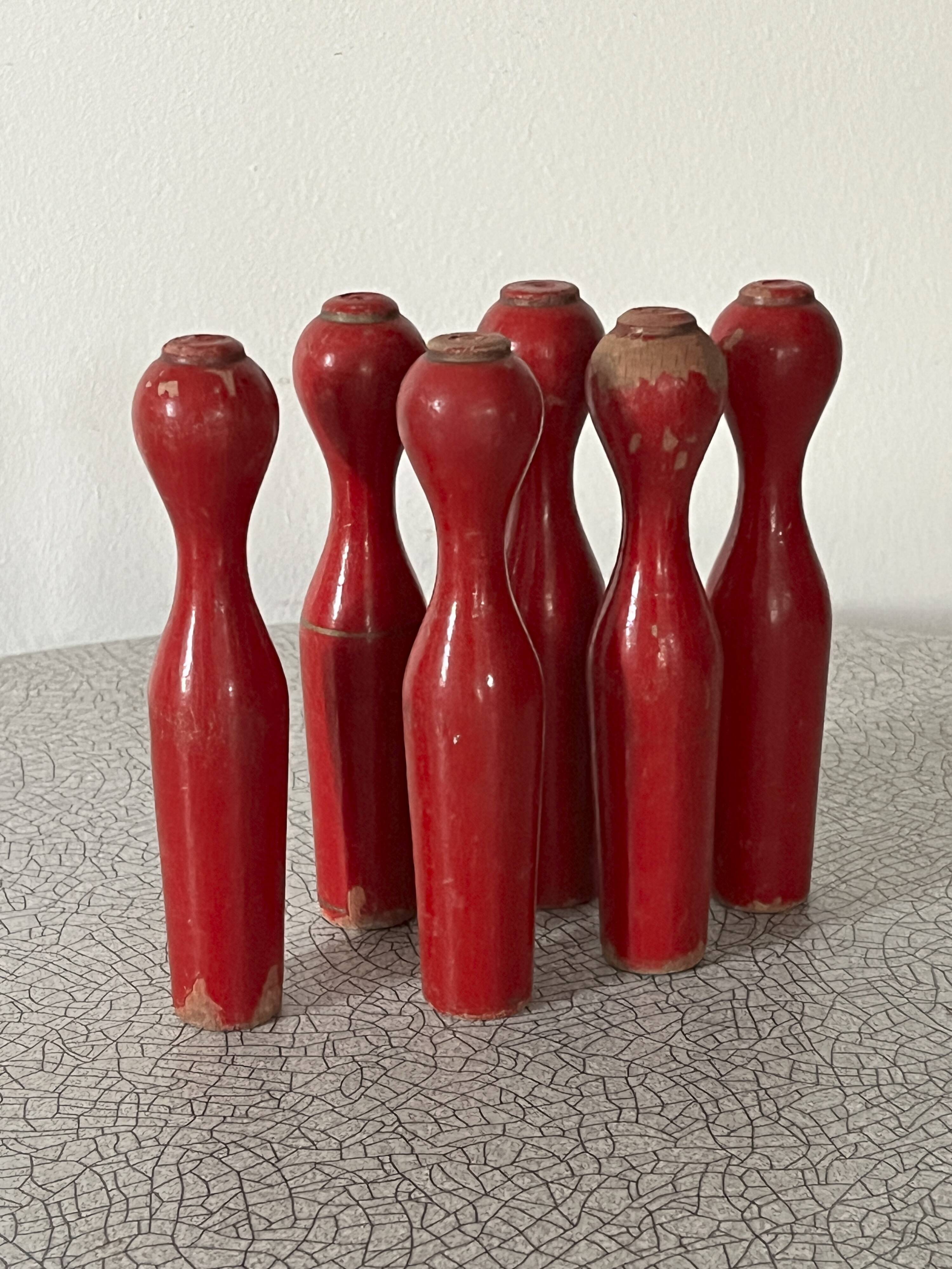 Set of old wooden bowling pins in red
