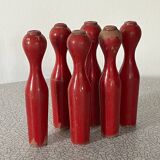 Set of old wooden bowling pins in red