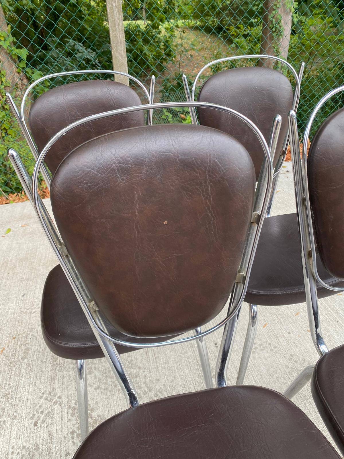 Set of 4 vintage chairs from the 60s/70s in brown faux leather with chrome compass legs.