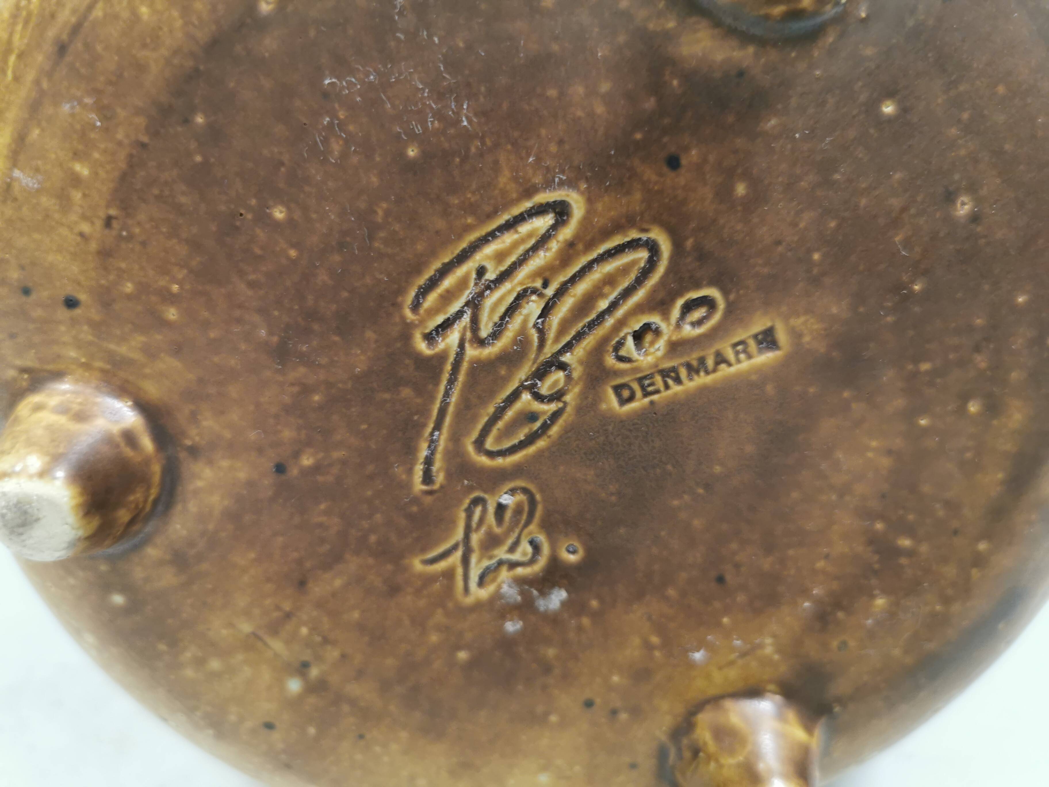 Small ceramic bowl with handle, in golden colours. Danish 1960-70s