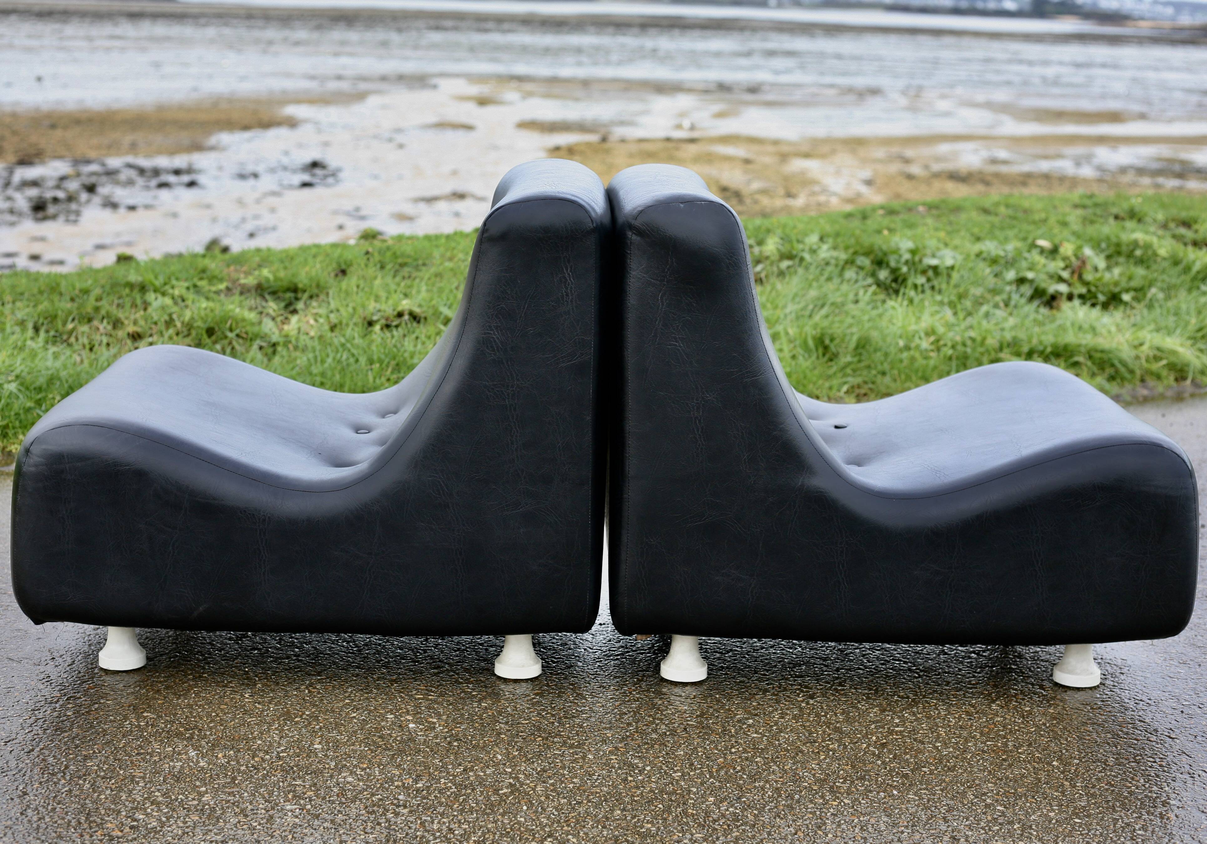 Pair of “space age” low chairs. Black faux leather. Circa 1970