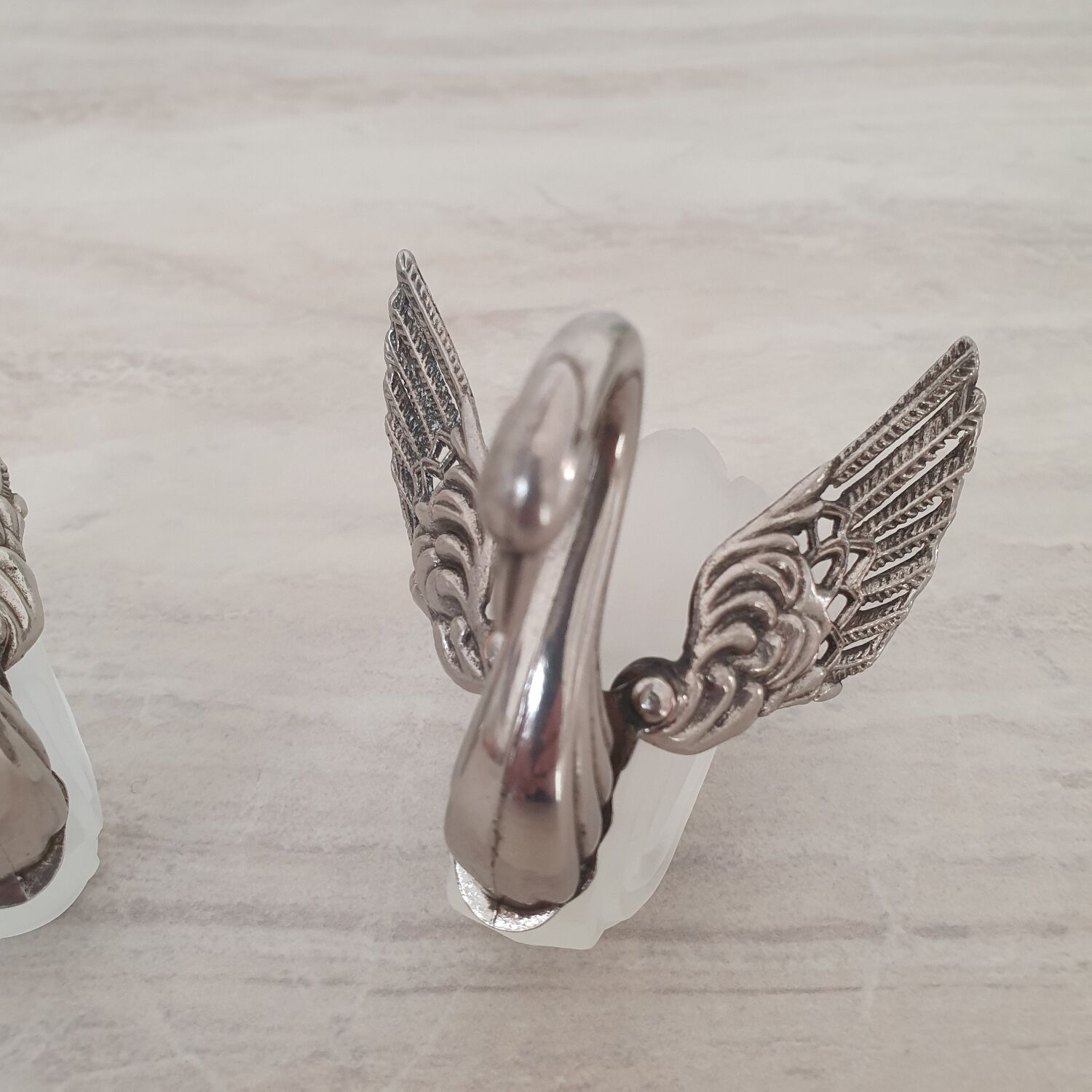 Two frosted glass swan salt cellars with silver plating.