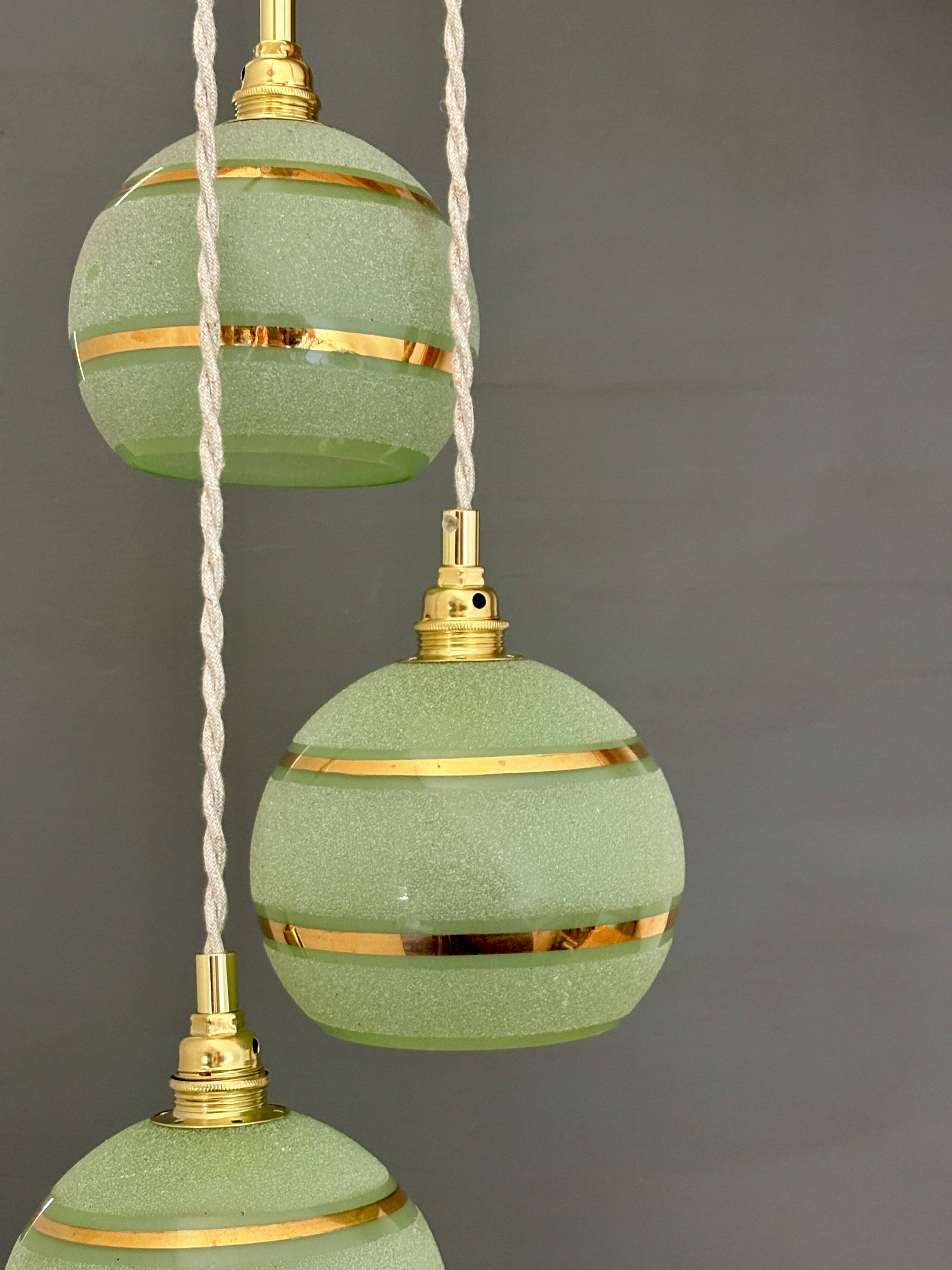 Suspension triple vintage glass globes in frosted green and gold.