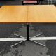 Table rises and lowers in light wood and metal.