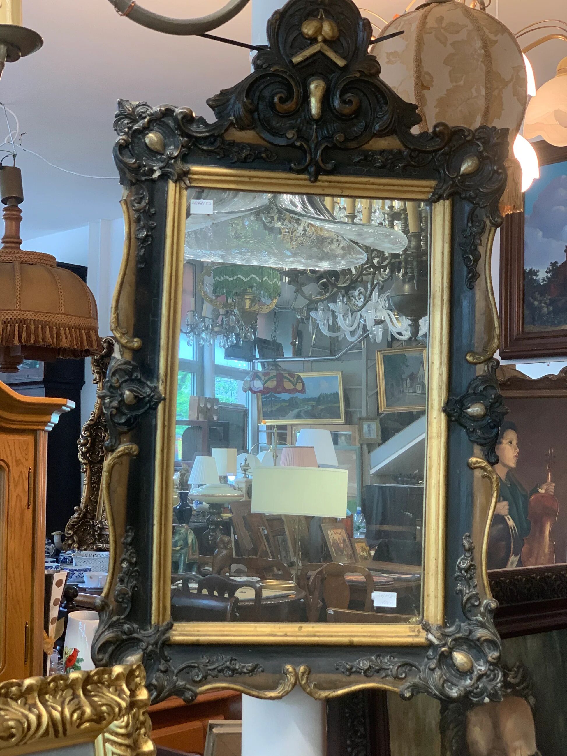 Antique bevelled mirror from the 19th century, sculpted and gilded frame.