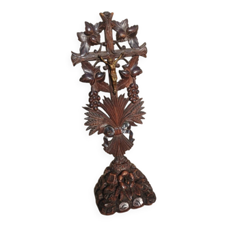Antique wooden crucifix carved from the Black Forest with grapes and leaves.