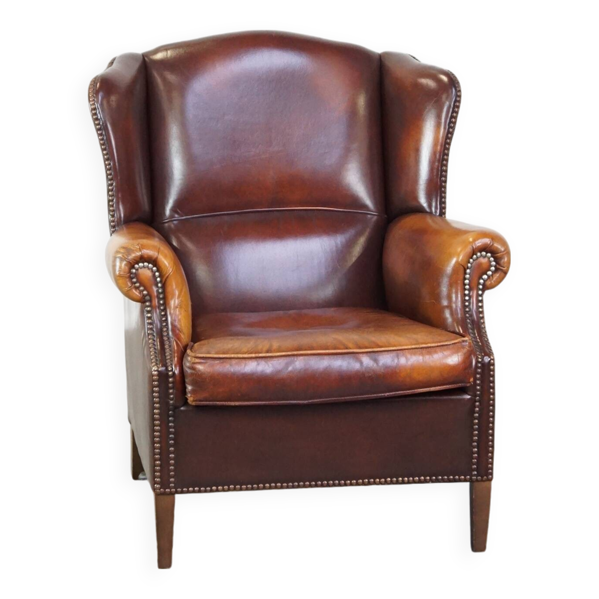 Comfortable, elegant, stately wing chair made of sheepskin in a beautiful warm color