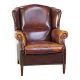 Comfortable, elegant, stately wing chair made of sheepskin in a beautiful warm color