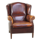 Comfortable, elegant, stately wing chair made of sheepskin in a beautiful warm color