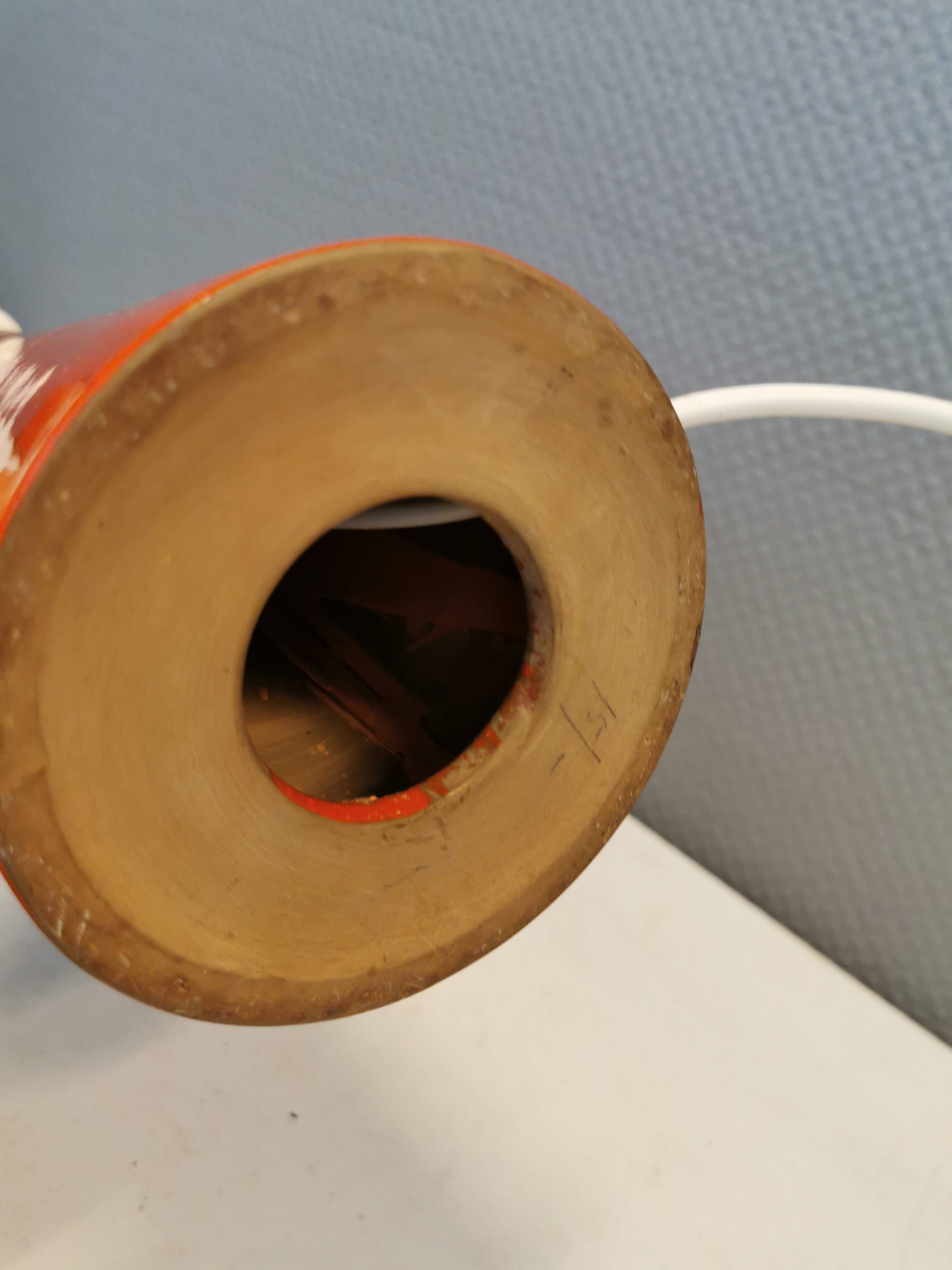 Ceramic table lamp with partial orange glaze.