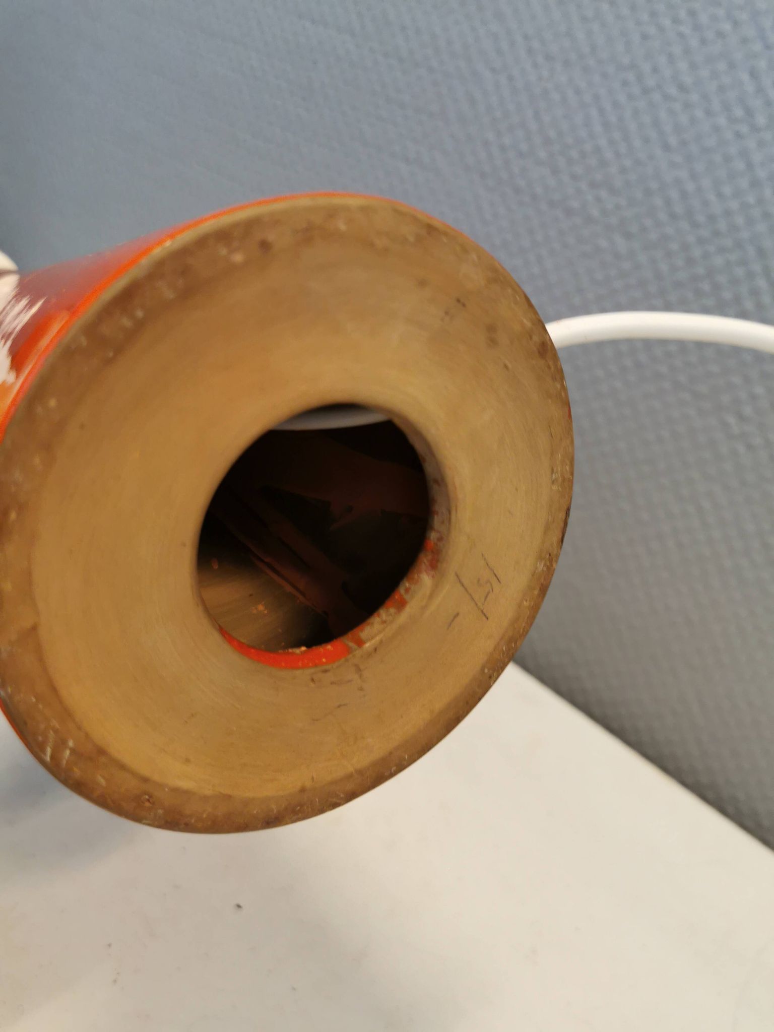 Ceramic table lamp with partial orange glaze.