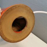 Ceramic table lamp with partial orange glaze.