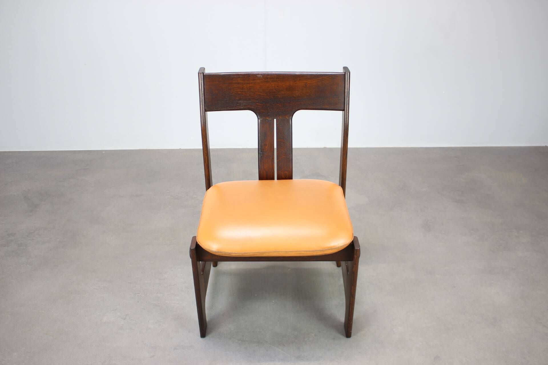 Vintage German sculptural chair from the 1970s in wood with orange faux leather.