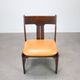 Vintage German sculptural chair from the 1970s in wood with orange faux leather.