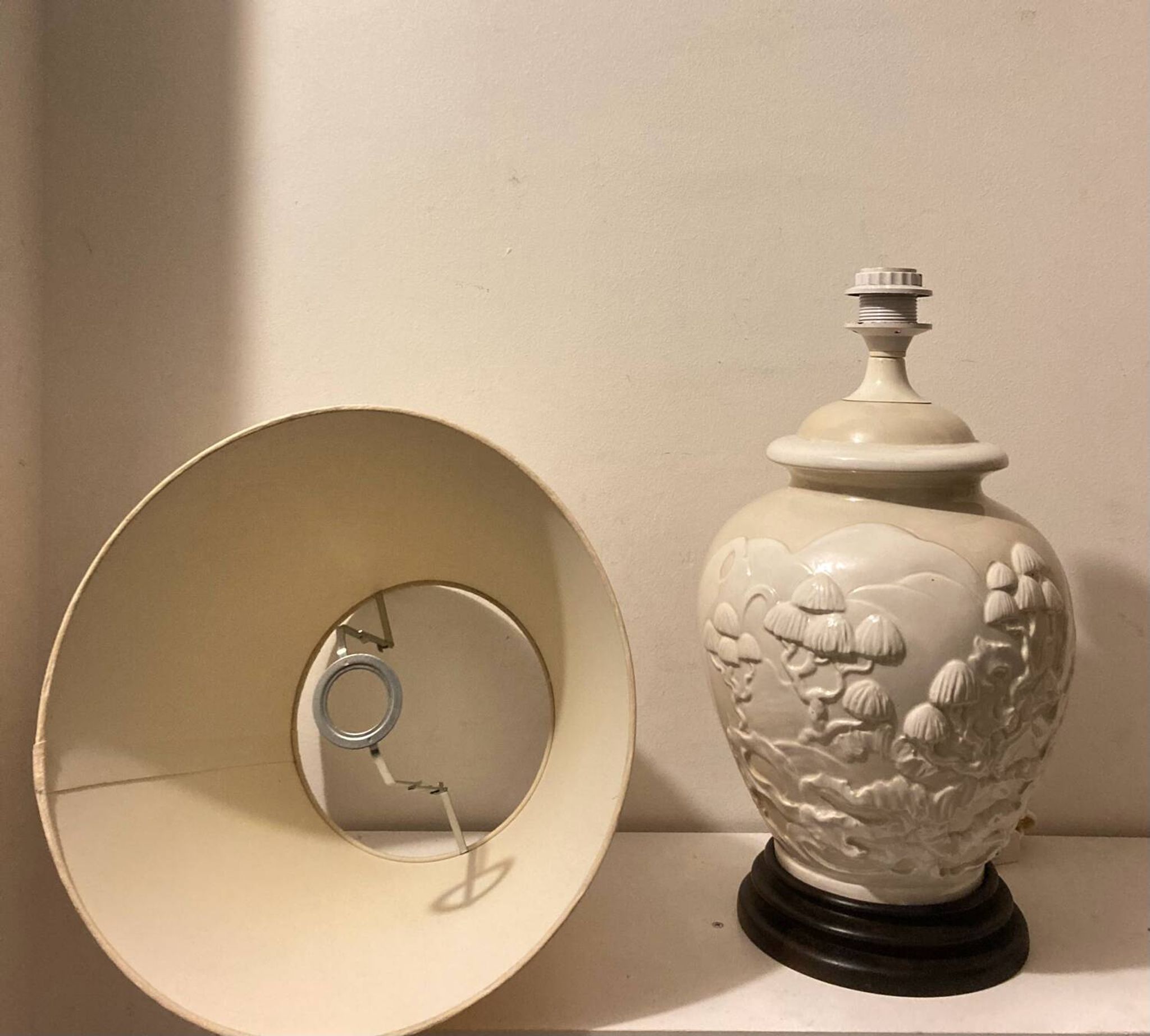 1980s ceramic table lamp with a wooden base and adjustable shade.