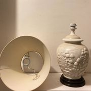 1980s ceramic table lamp with a wooden base and adjustable shade.