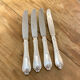 Series of 4 silver metal rocaille knives