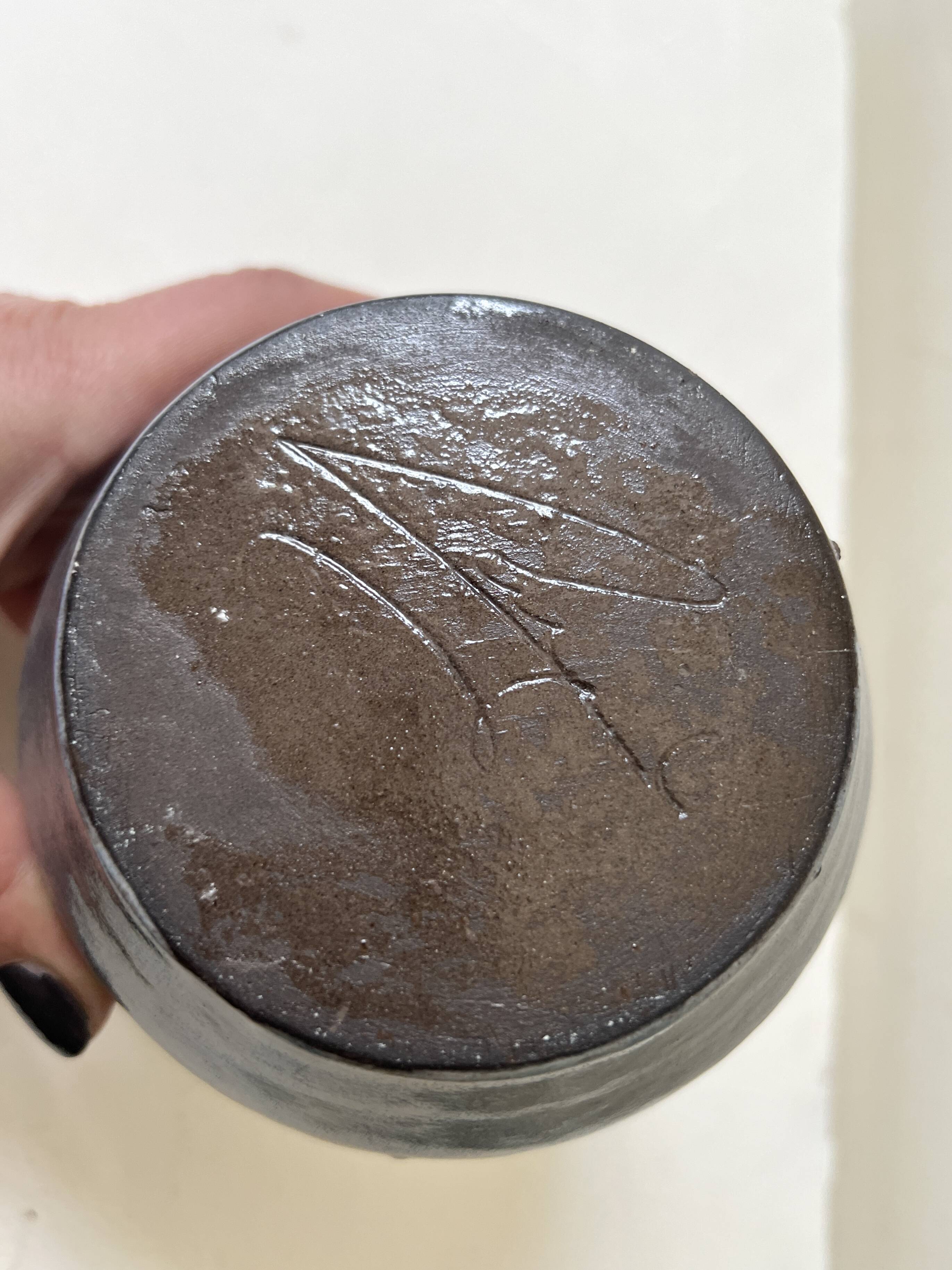 Glazed ceramic vase with a narrow neck and signed, unique piece.