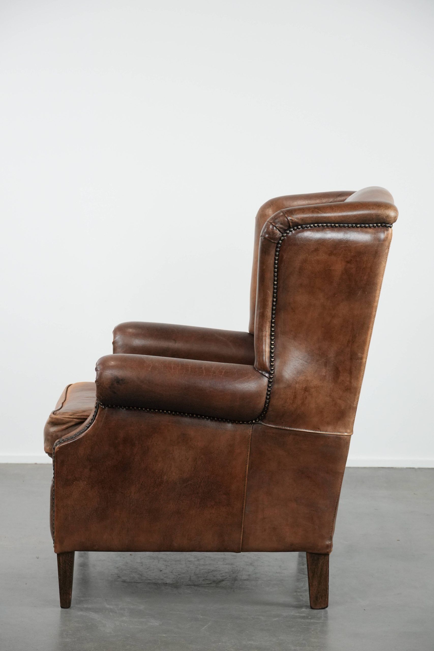 Warm, cosy and comfortable vintage sheepskin ear armchair with character