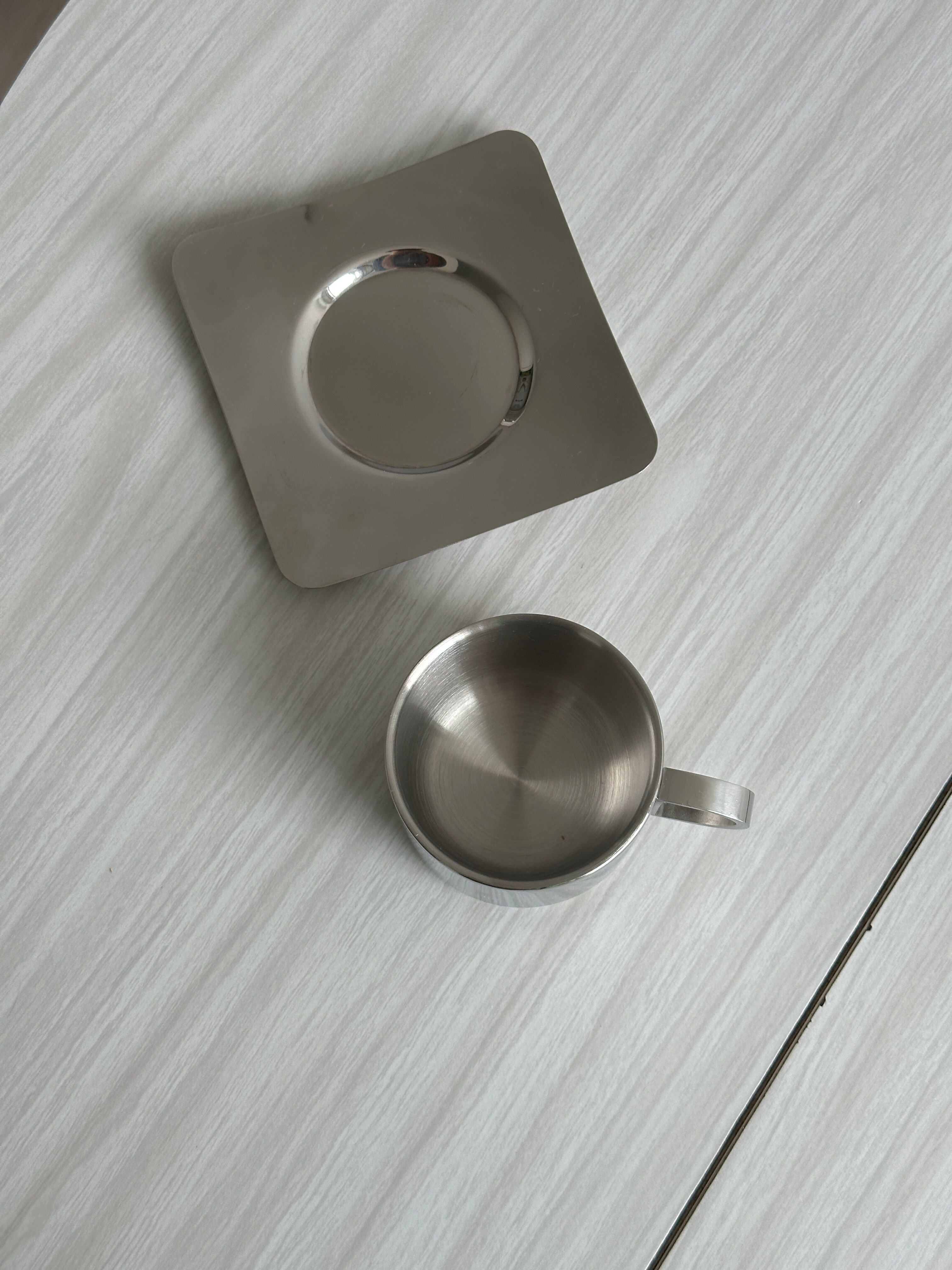 set of 4 stackable stainless steel coffee cups with saucers