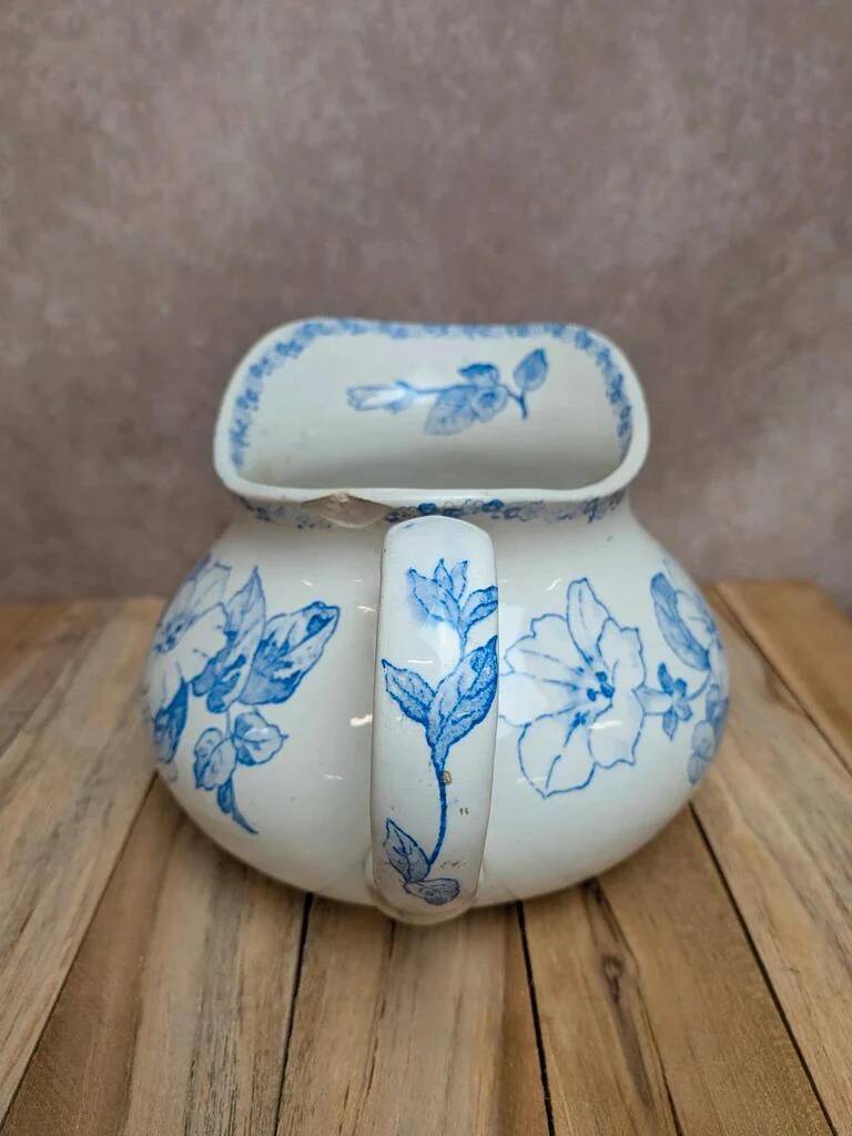 Small antique ironstone jug L.m Creil and Montereau with blue floral decoration.