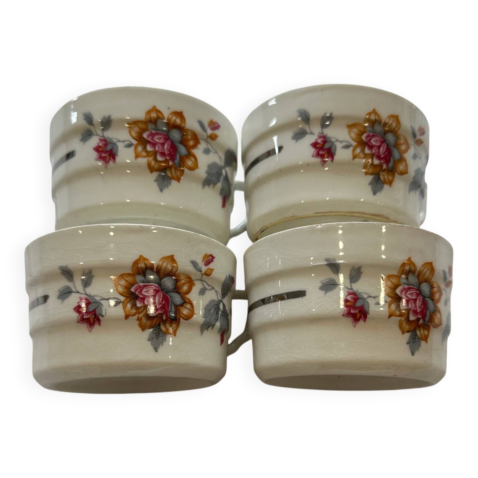 Set of 4 fine porcelain coffee cups with floral patterns and silver accents.