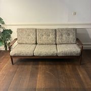 Vintage 3-seater wooden sofa with sculptural backrest.