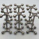 Set of 6 old table knife resistors in the shape of crossbars in silver metal