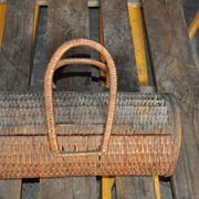 Vintage brown wicker cylindrical basket from the 1940s — long case for a bottle