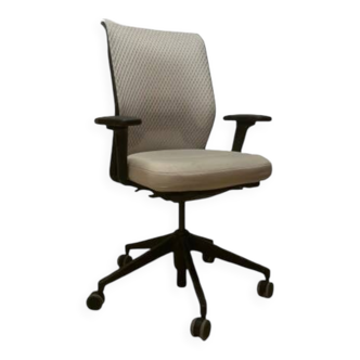 Office chair with wheels and mesh backrest.