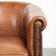 Sheepskin club armchair with a cognac colour finished with decorative nails