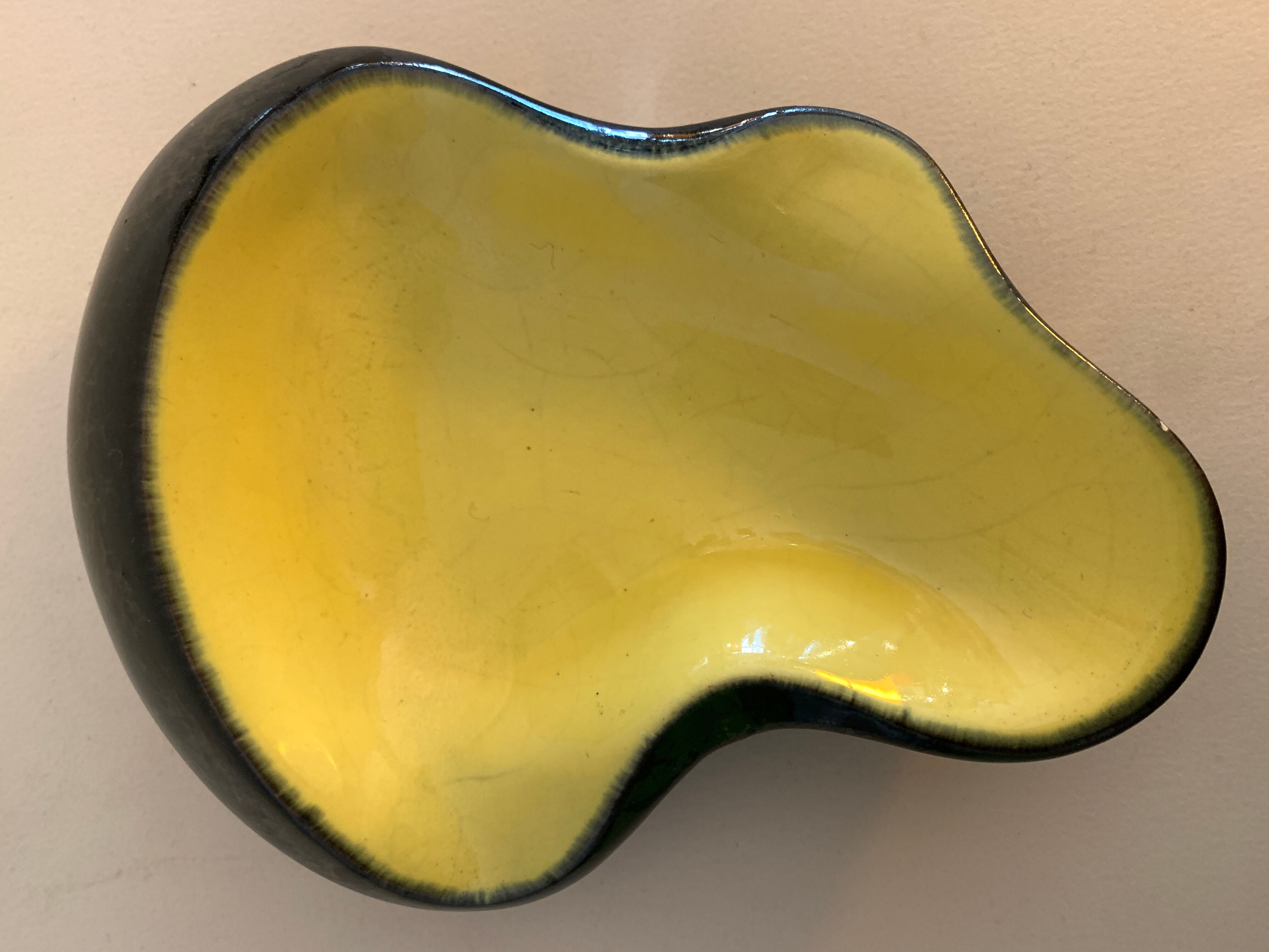 Yellow and black ceramic ashtray