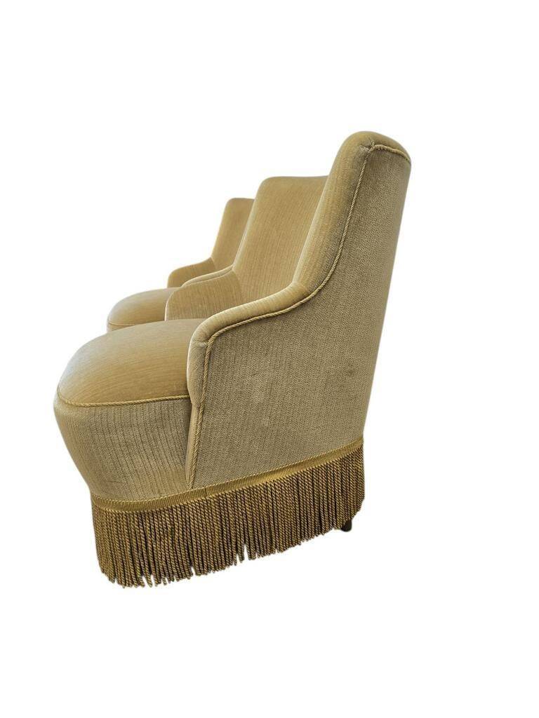 Set of 2 vintage 'gold' armchairs with fringes.