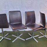 Set of 4 metal and imitation leather swivel chairs.
