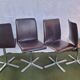 Set of 4 metal and imitation leather swivel chairs.