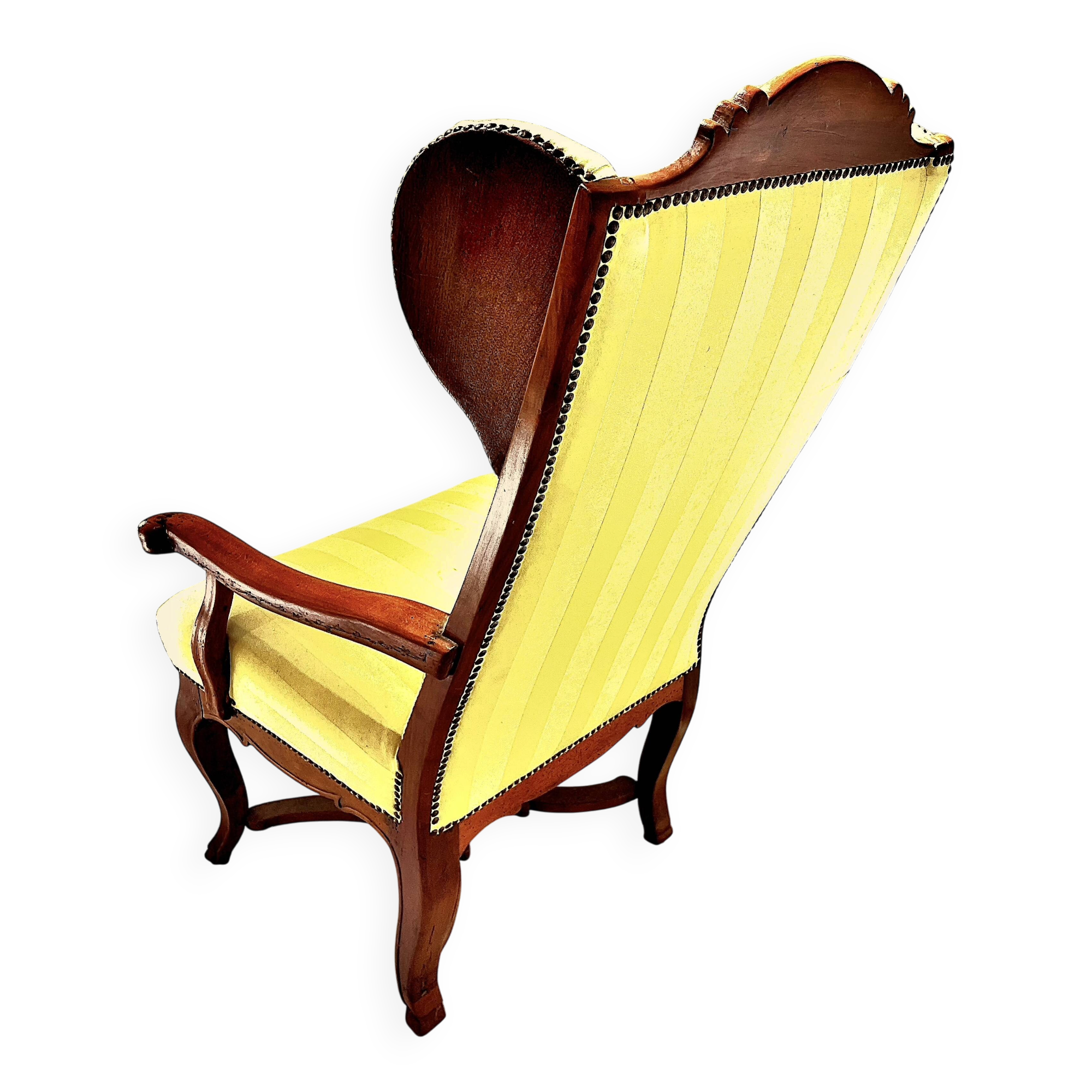 Wingback armchair in walnut in the French Regency style with stretcher in