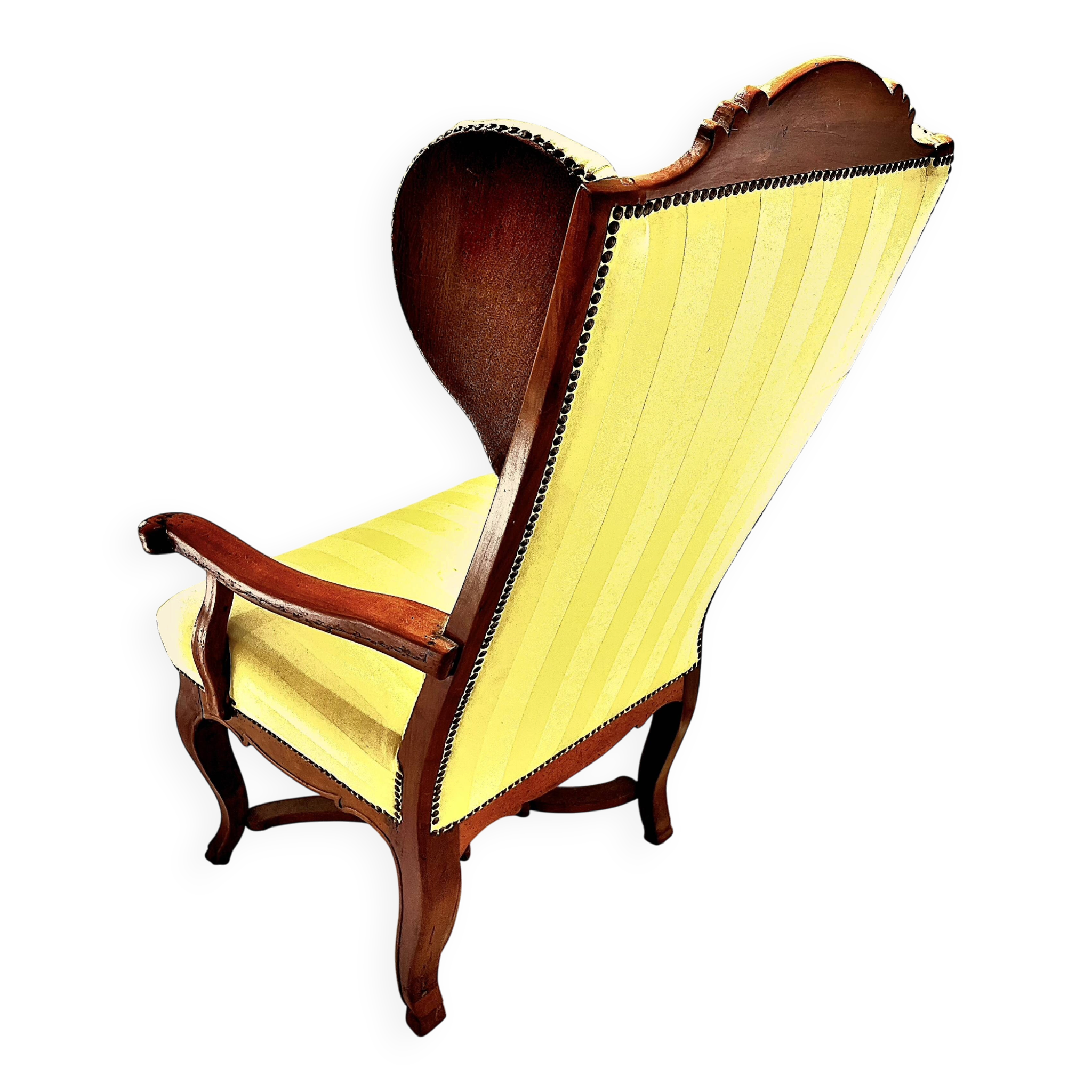Wingback armchair in walnut in the French Regency style with stretcher in