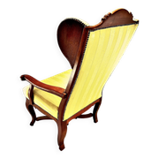 Wingback armchair in walnut in the French Regency style with stretcher in