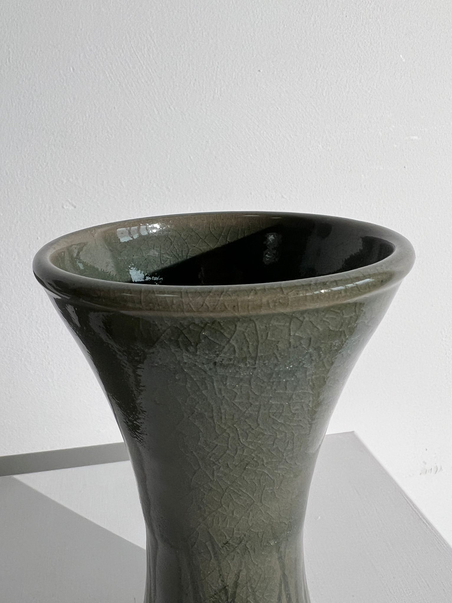 Dark green handcrafted vase with glazed ceramic grass blades