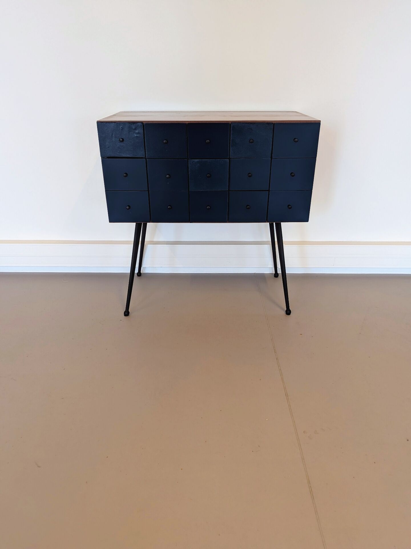 Vintage workshop furniture with 15 blue drawers.