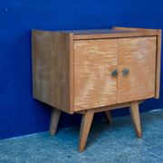 Rockabilly design bedside table with tapered legs.