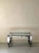Brushed chrome coffee table with glass, 2 tiers on wheels, 1970s design.