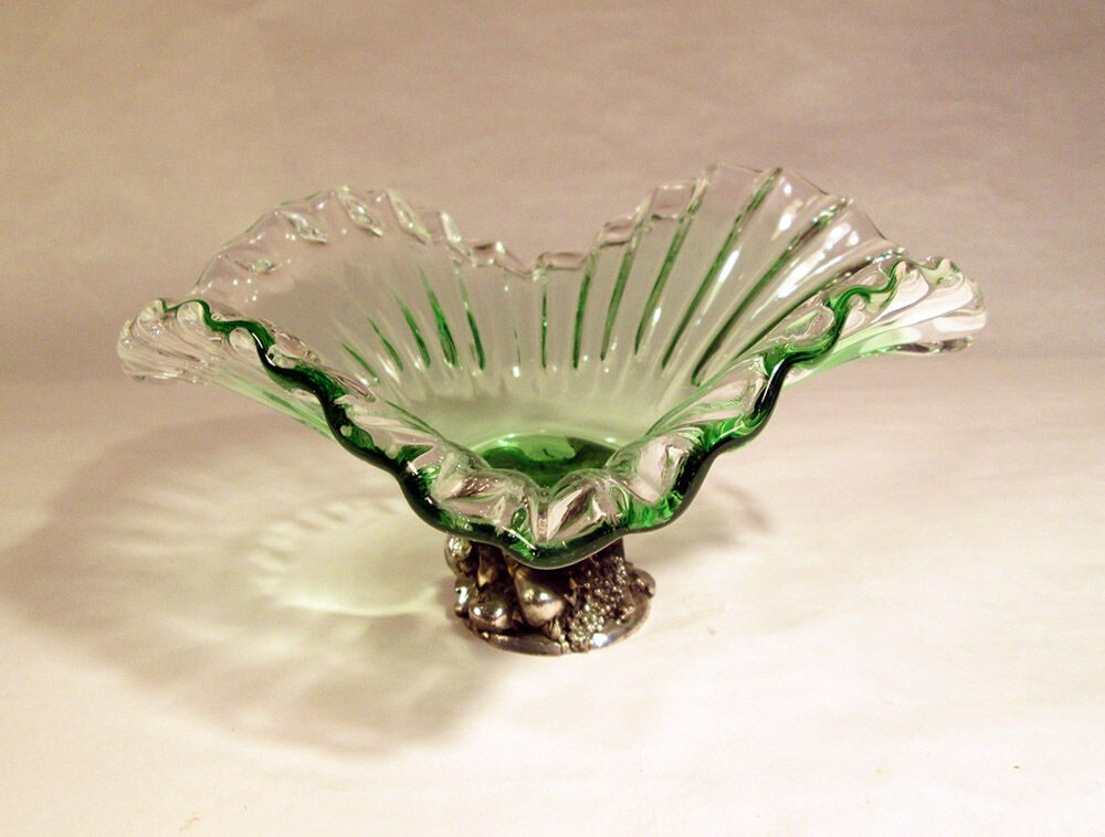 Glass cup on decorated metal stand